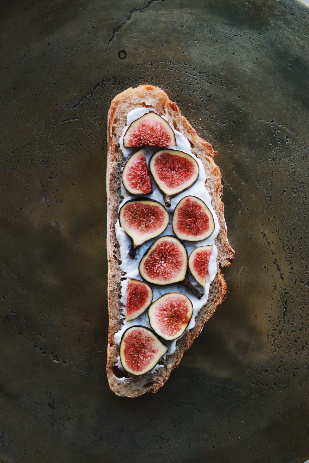 Sourdough toast spread with cream cheese and topped with fresh sliced figs